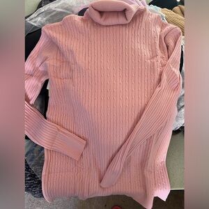 The sweater is brand new. It is a beautiful quality, pink turtleneck sweater.